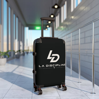 La Discipline Logo Carry-On Suitcase – Black Hard-Shell Travel Luggage Printify